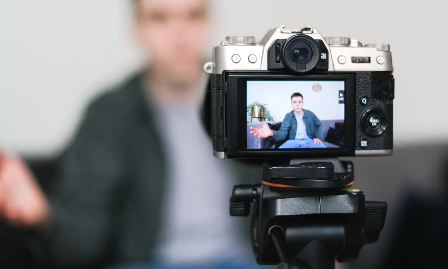 A creator filming a video with a camera on a tripod