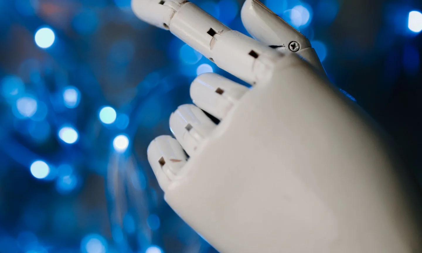 A robotic hand against blue lights