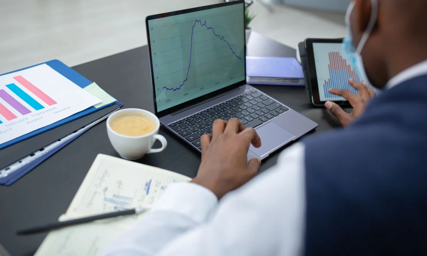 A professional reviewing information on a laptop