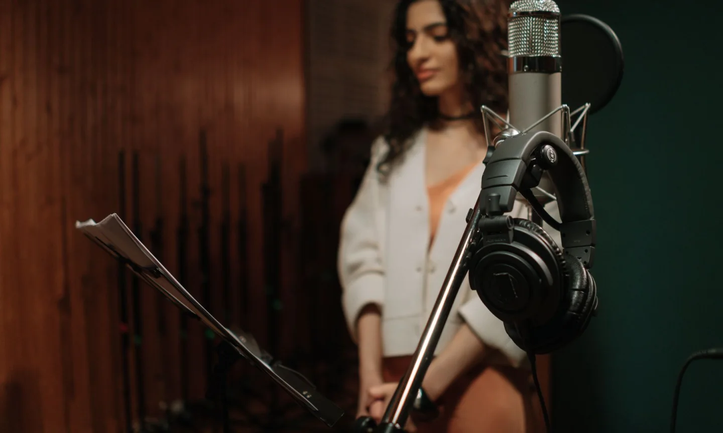 A microphone and headphones in a recording space