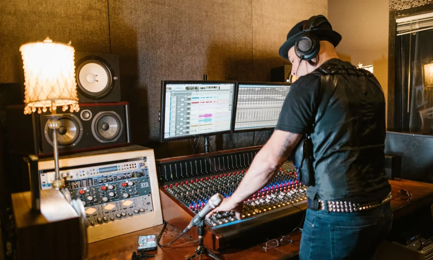 A producer working at a studio mixing console