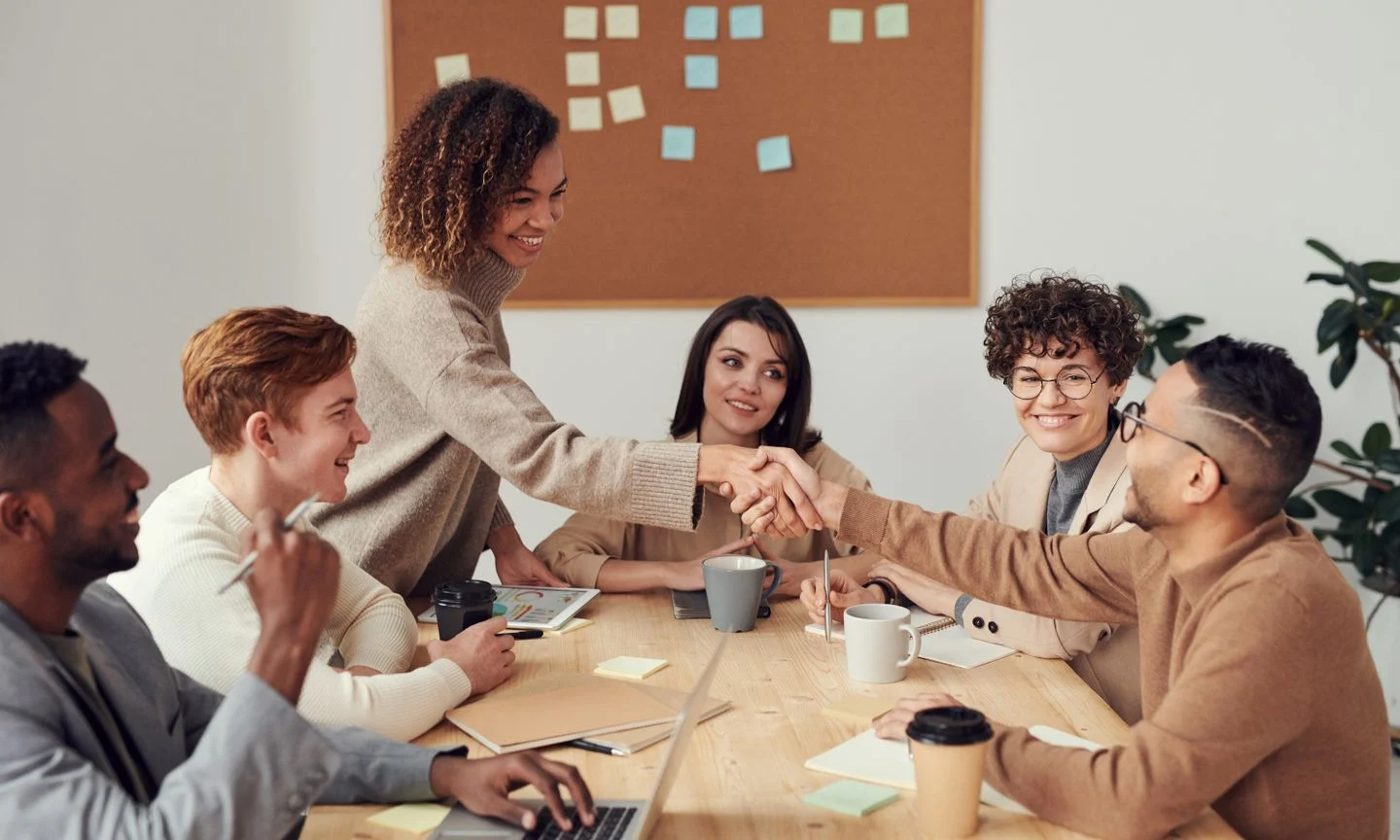 Colleagues discussing work around a table