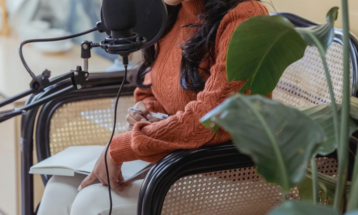 A speaker recording an interview into a studio microphone