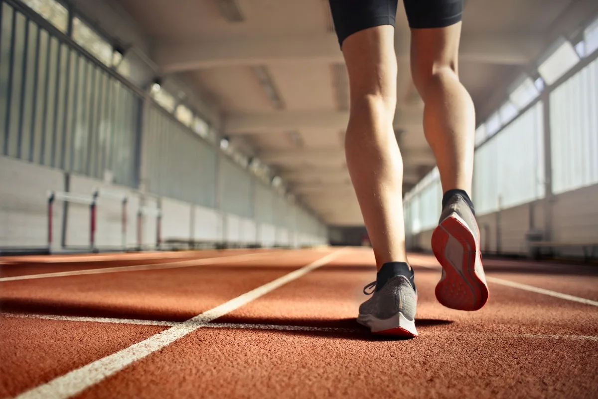 Runner’s shoes on a red indoor track