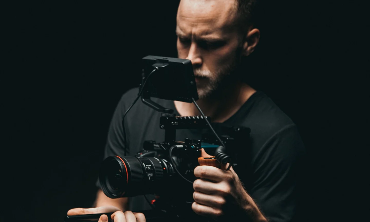 Videographer adjusting a camera rig